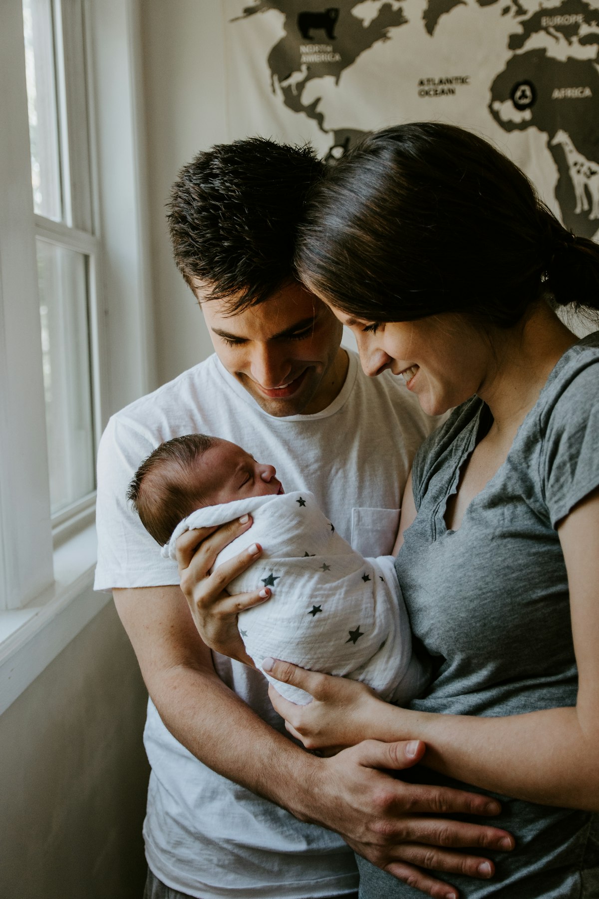 Parents smiling with their baby during a wellness visit